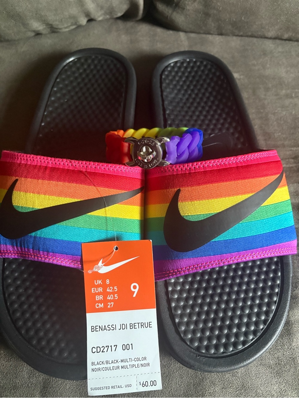 Pride bundle featuring Nike Benassi JDI BETRUE Slides and Love is Love bracelet